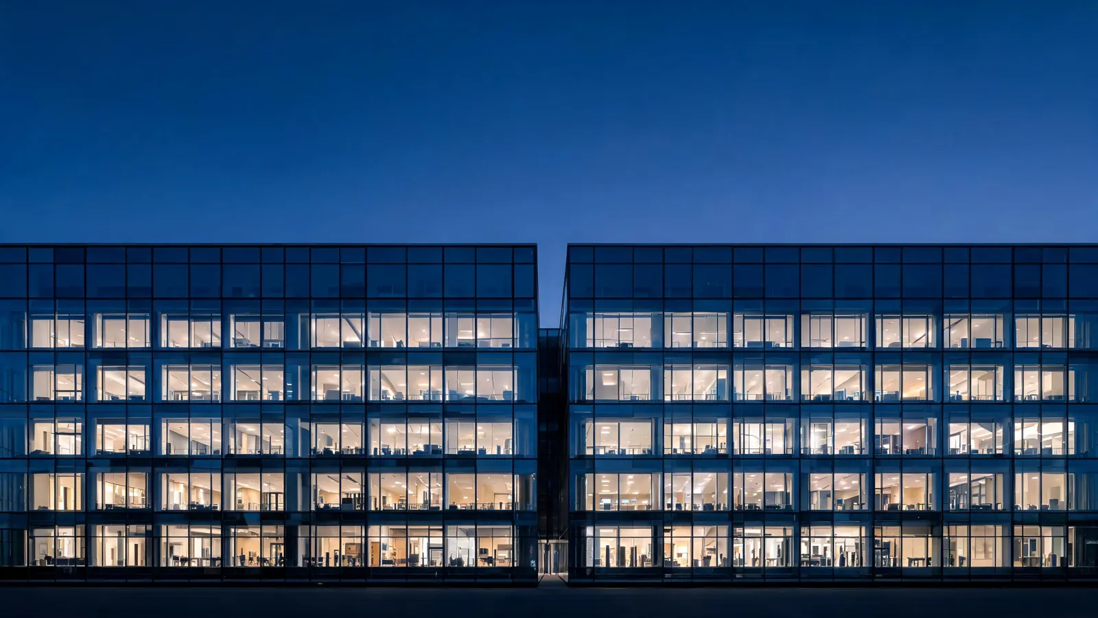 A glass laboratory building at dusk